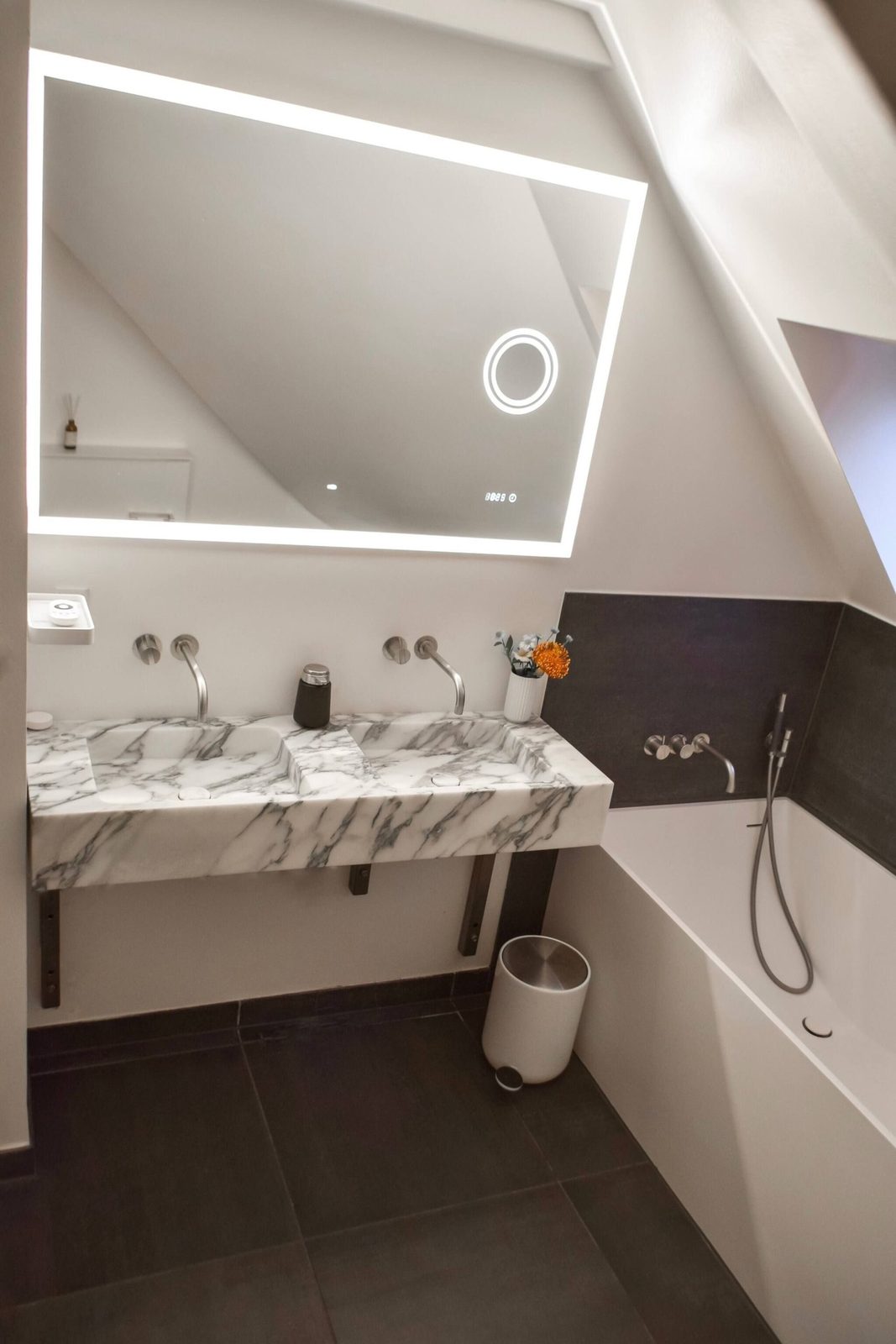 Main bathroom with marble double vanity and bathtub